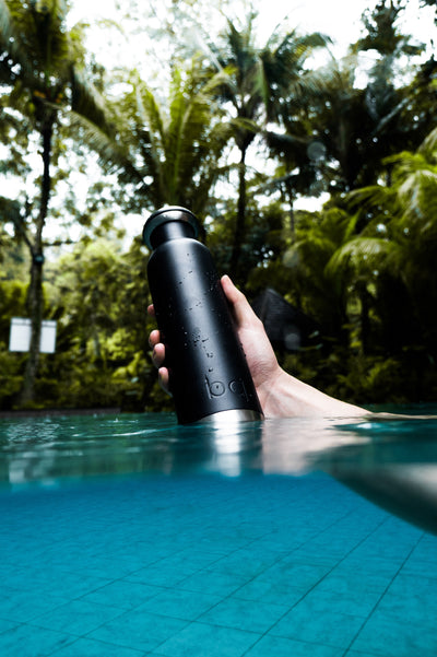 black bq bottle in the pool