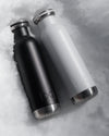 black and white hydration bottle in snow
