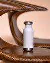 small 300ml white bq bottle on leather chair