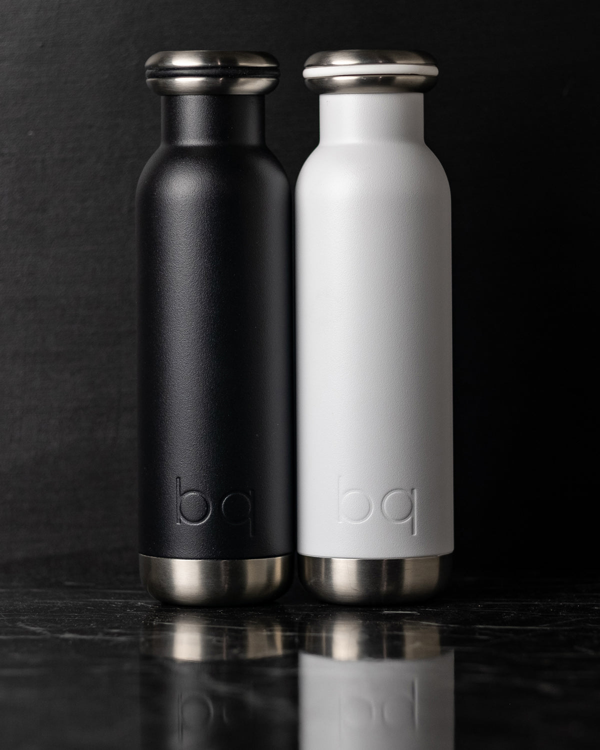 close up black and white bq bottles