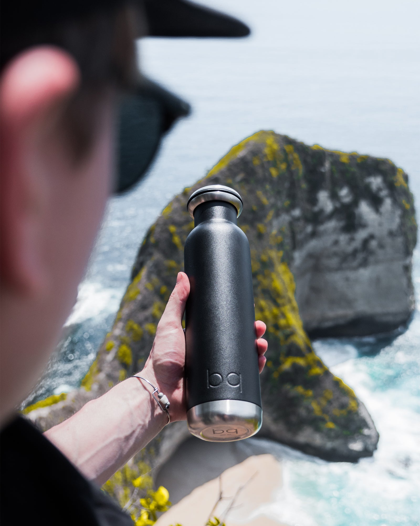 Spring break holding black water bottle with sunglasses