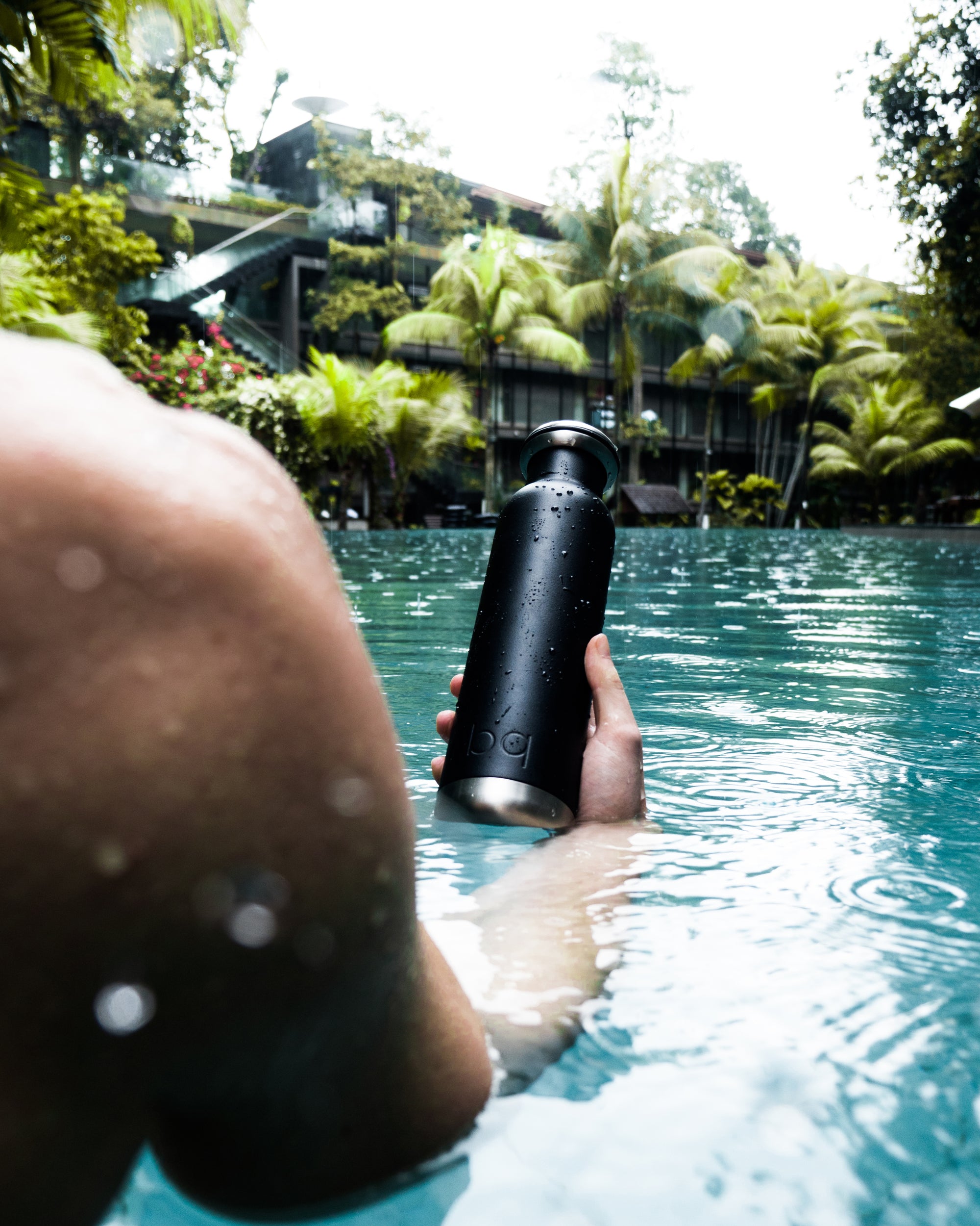 vacation in the pool with black bq bottle